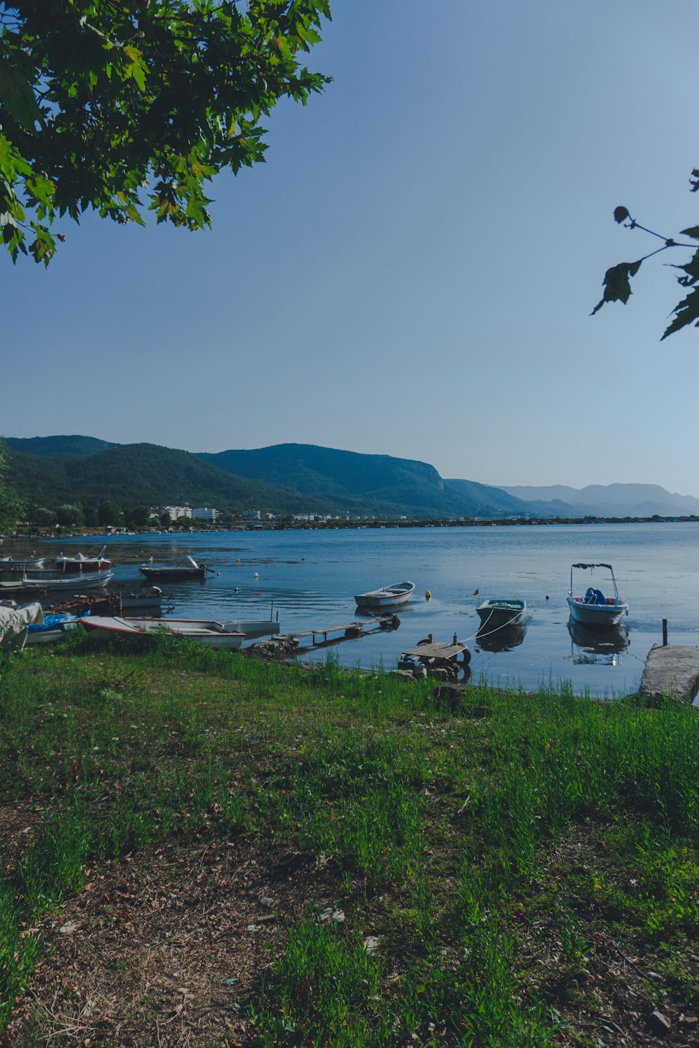 boats on sea near mountain during daytime