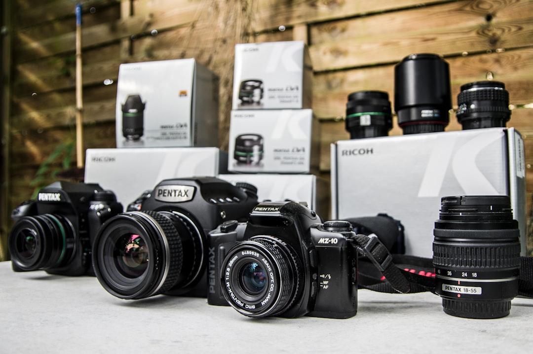 black nikon dslr camera on white table