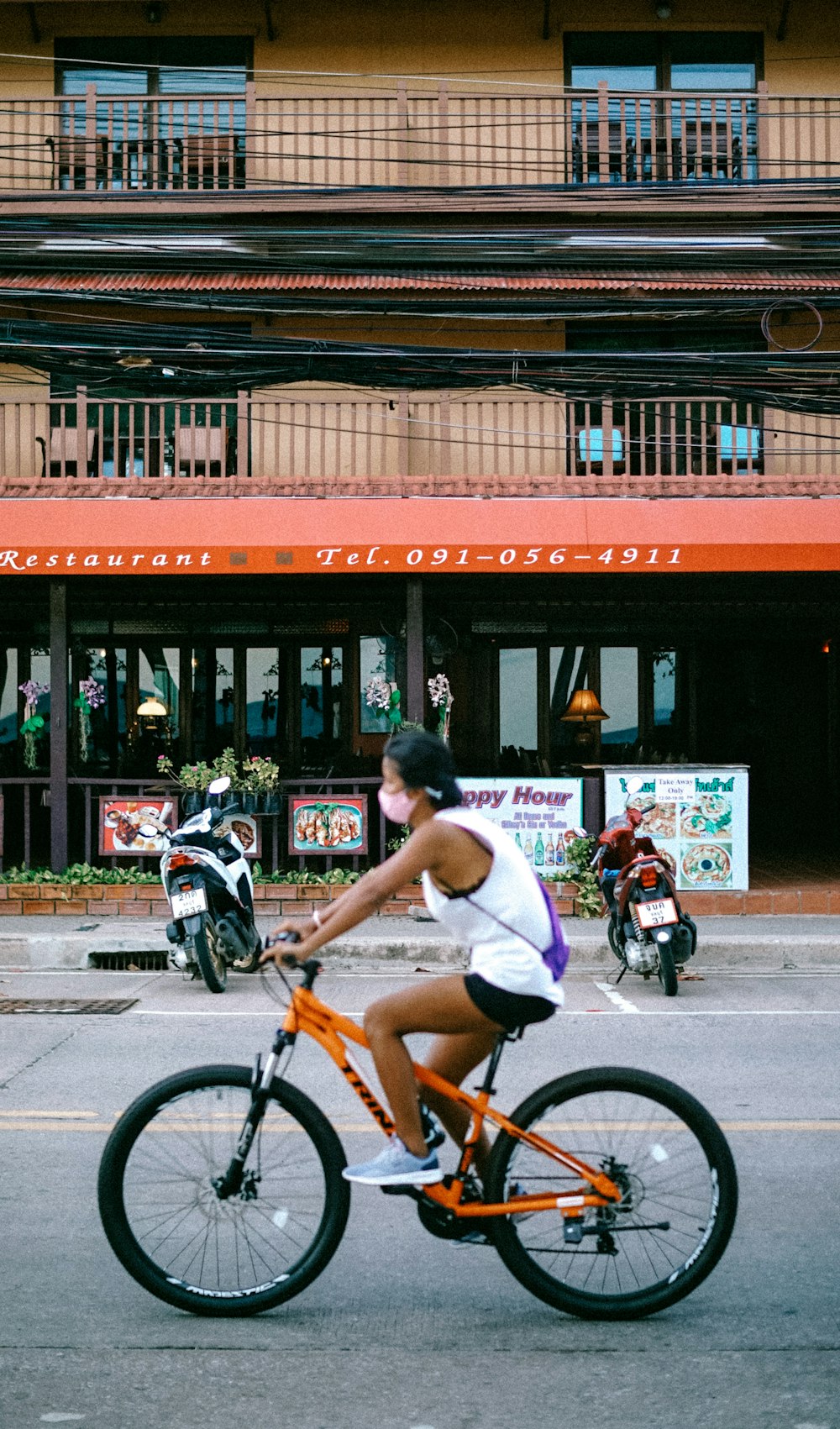 man in white shirt riding on bicycle during daytime