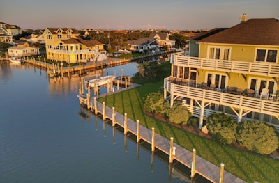 white and brown concrete building beside body of water during daytime