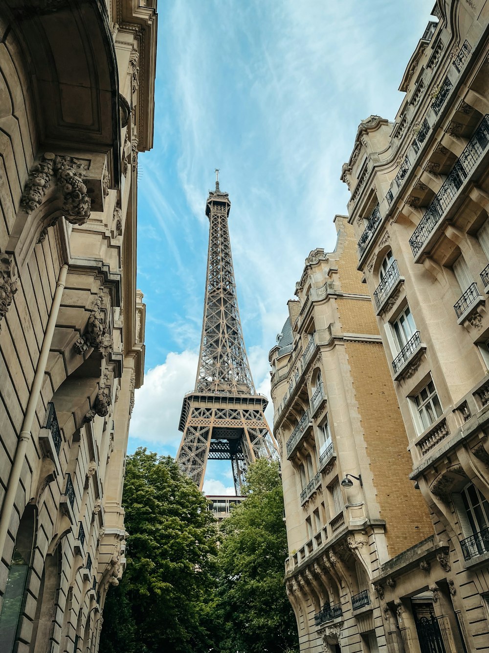 eiffel tower under white clouds and blue sky during daytime