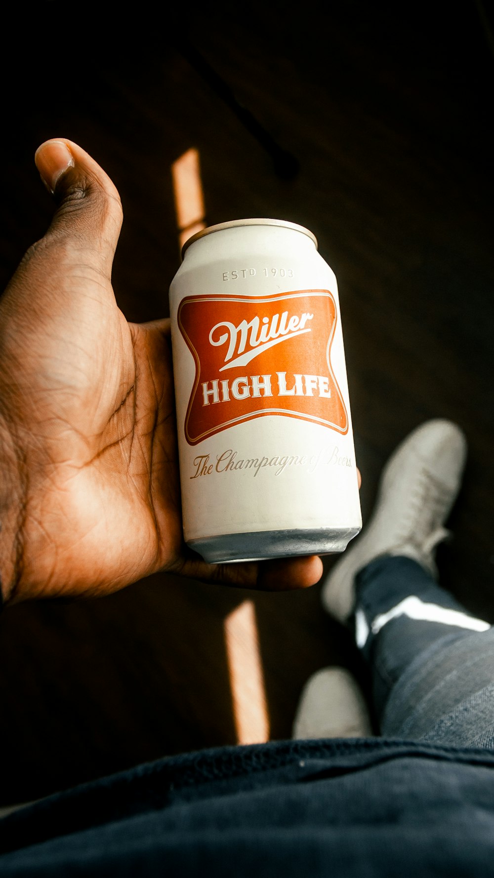 person holding white and brown plastic bottle