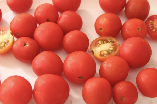 Red tomato on white table