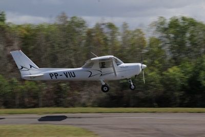 white and black jet plane on the road during daytime