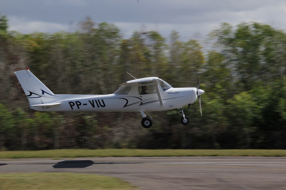 white and black jet plane on the road during daytime