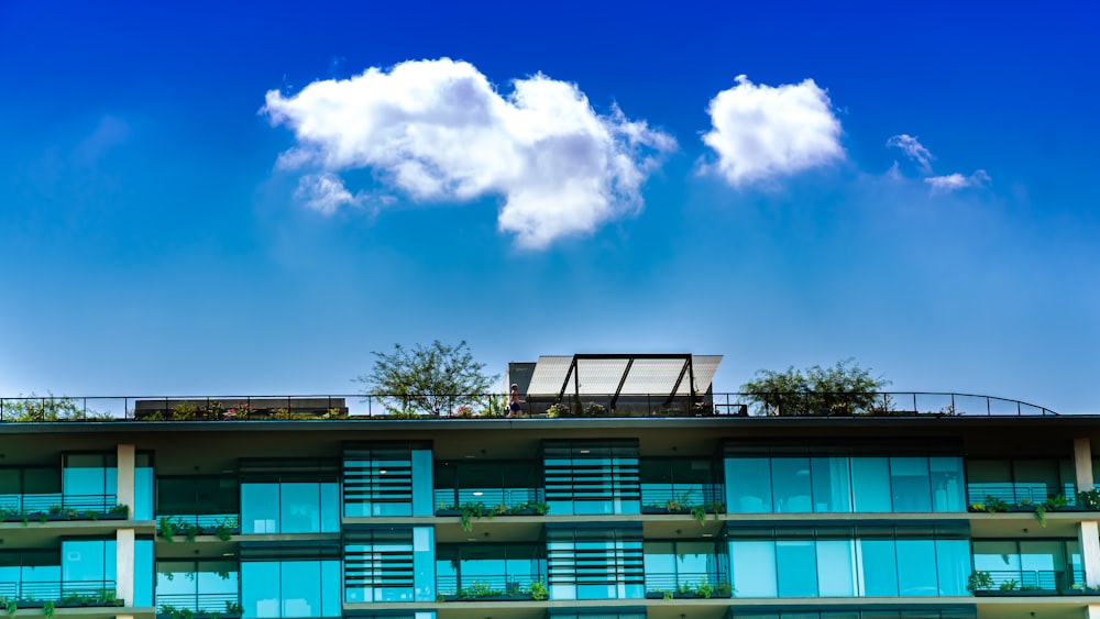 blue and white concrete building under blue sky and white clouds during daytime