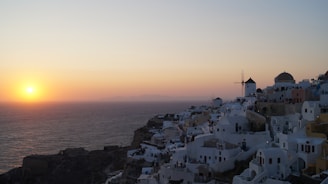 A warm sunset over a charming whitewashed village in Cádiz with cobblestone streets.