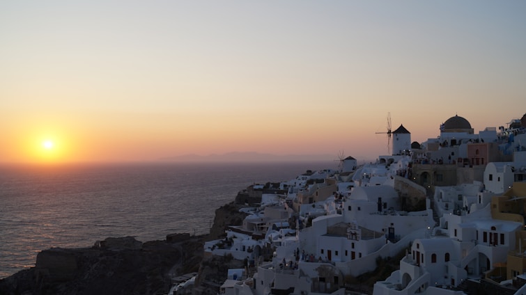 A warm sunset over a charming whitewashed village in Cádiz with cobblestone streets.