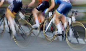 man in blue and red shorts riding bicycle