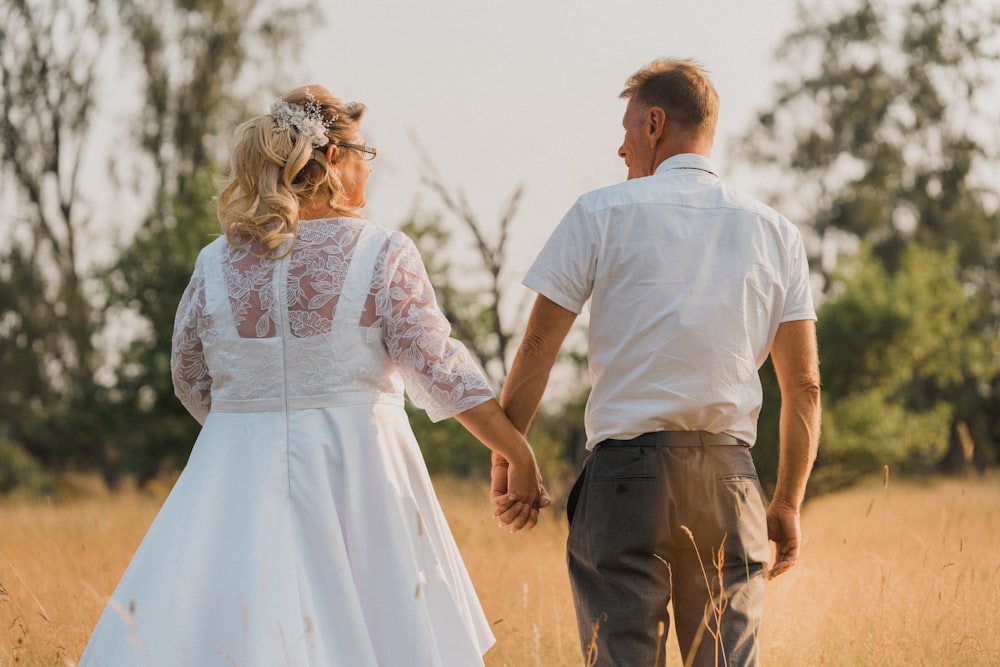 man in white shirt and woman in white dress