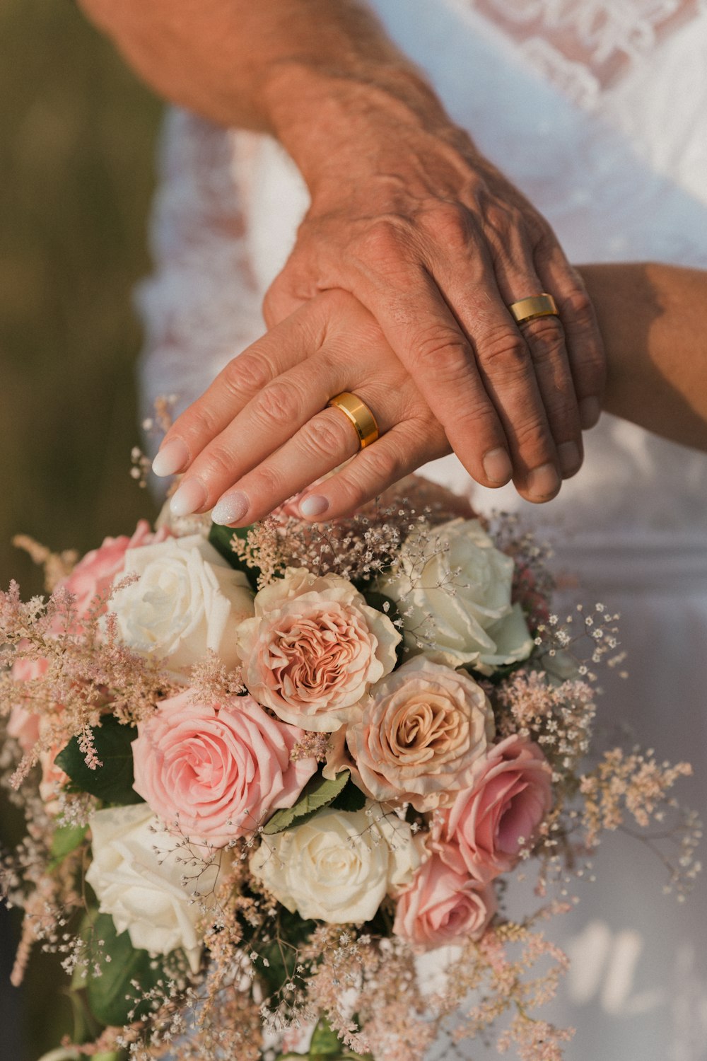 person holding bouquet of pink roses