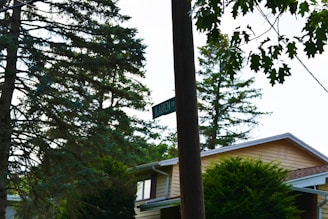 A custom wooden address sign mounted on a rustic post, blending seamlessly with a home's exterior.