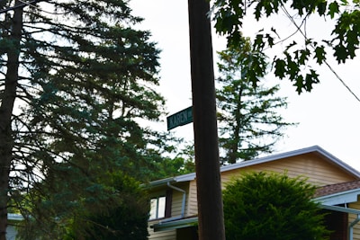 A close-up of a well-placed real estate sign in front of a beautiful home.