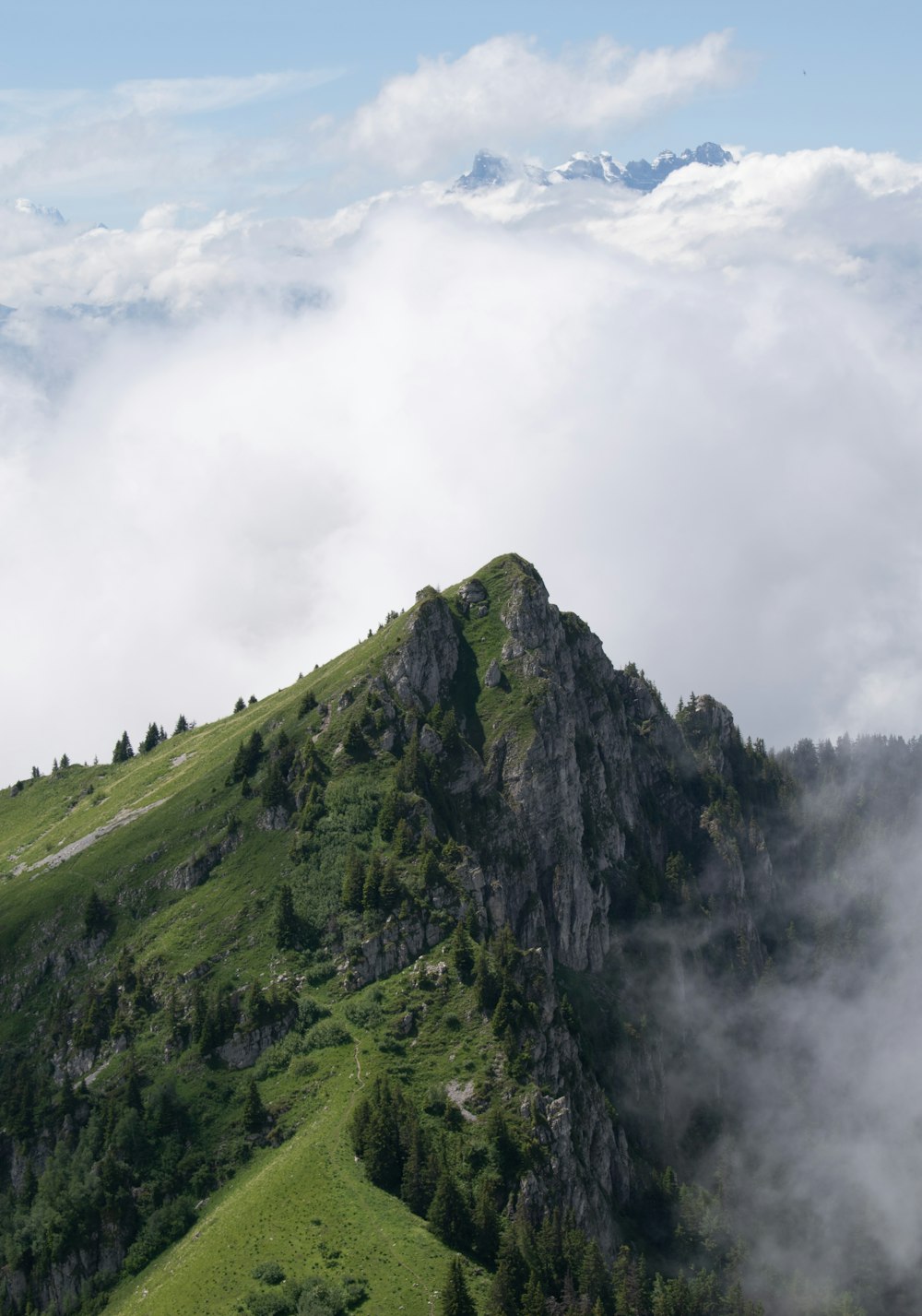 green mountain under white clouds during daytime