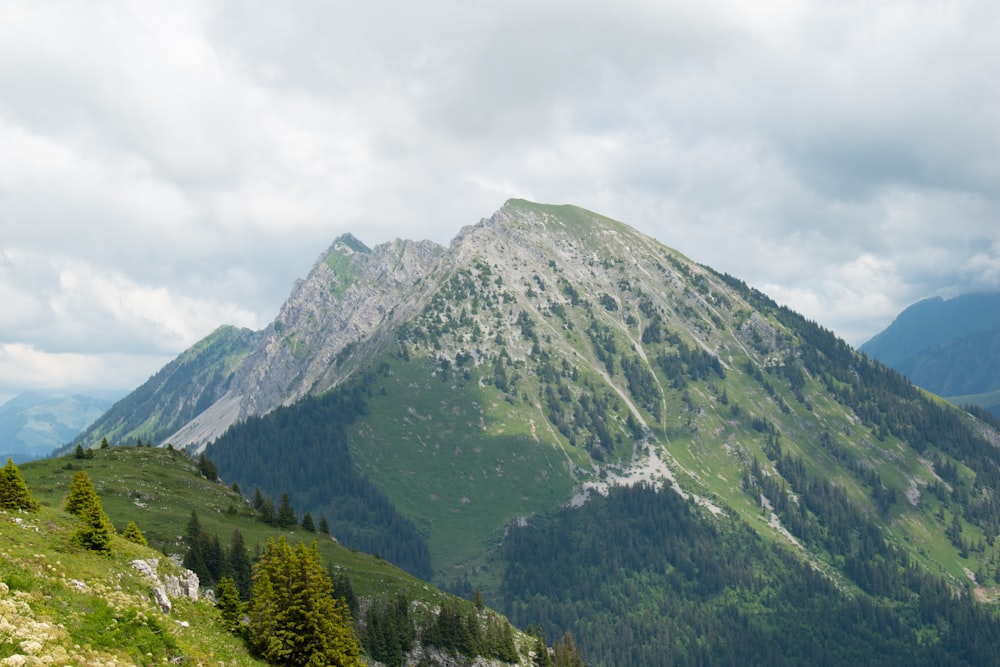 green and gray mountain under white cloudy sky during daytime