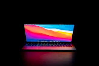 Latest laptops displayed with vibrant backgrounds.
