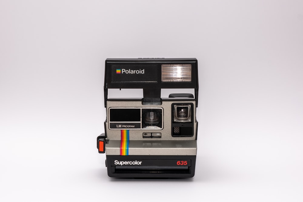 black polaroid instant camera on white surface