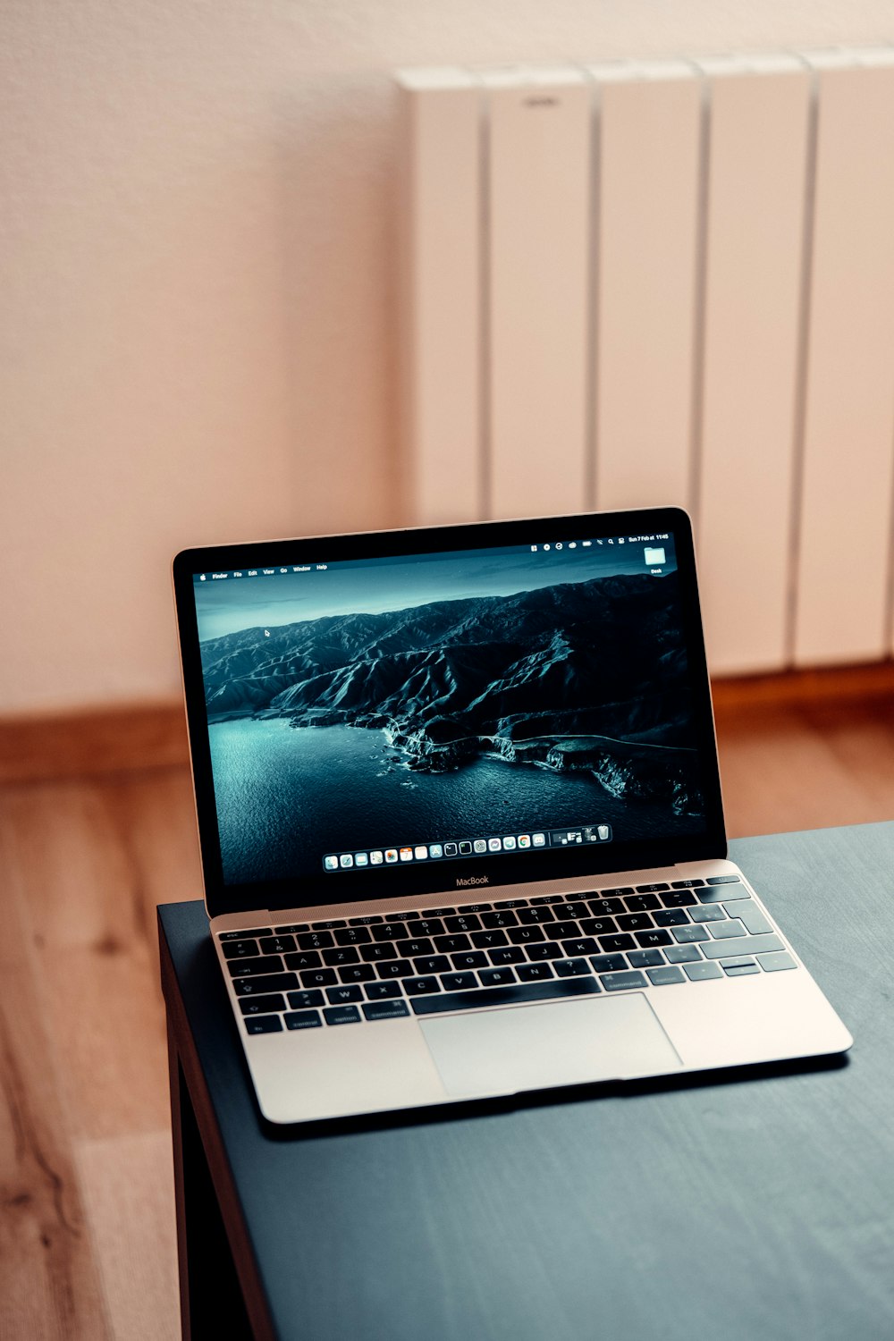 macbook pro on brown wooden table