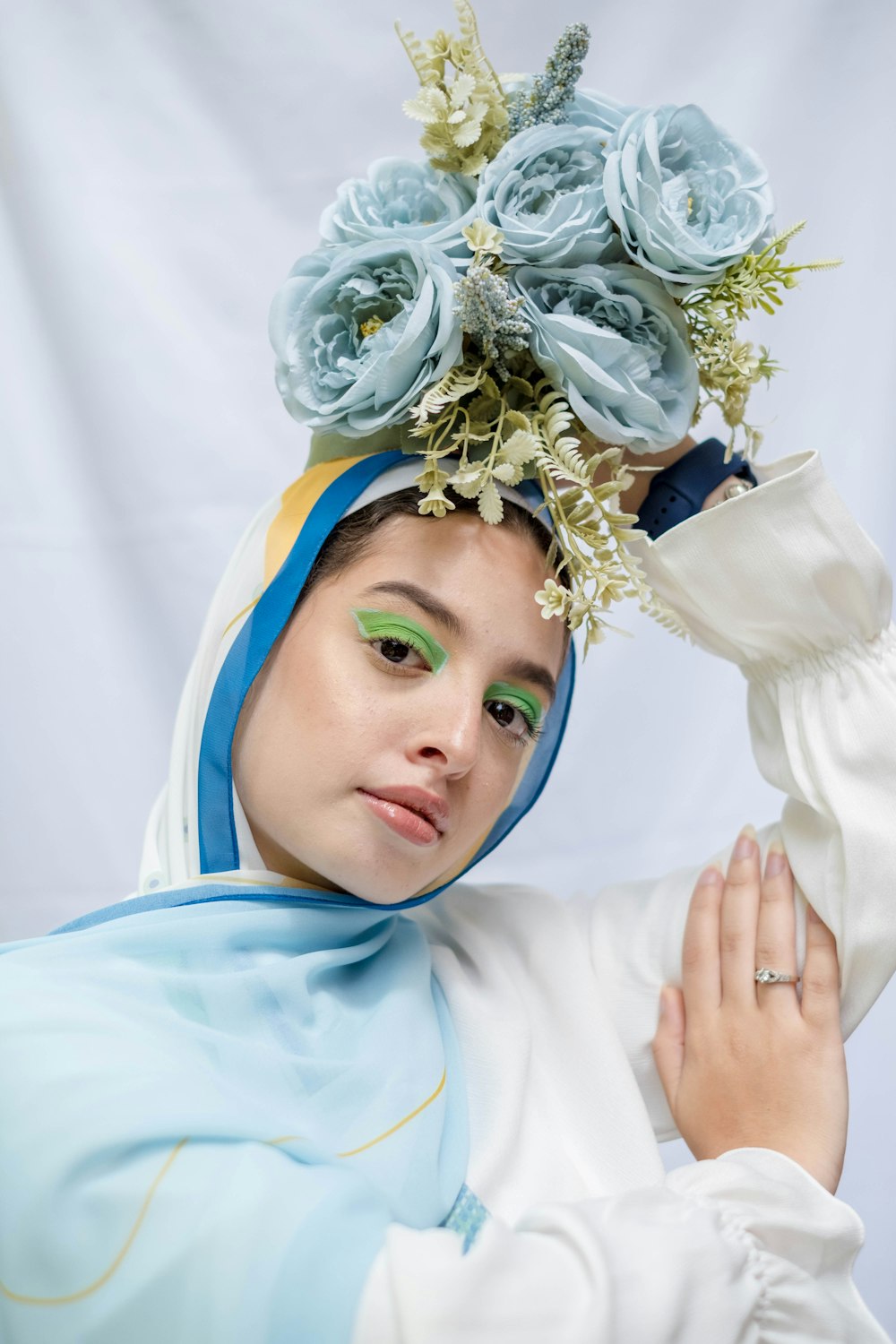 woman in white hijab with white flower on head