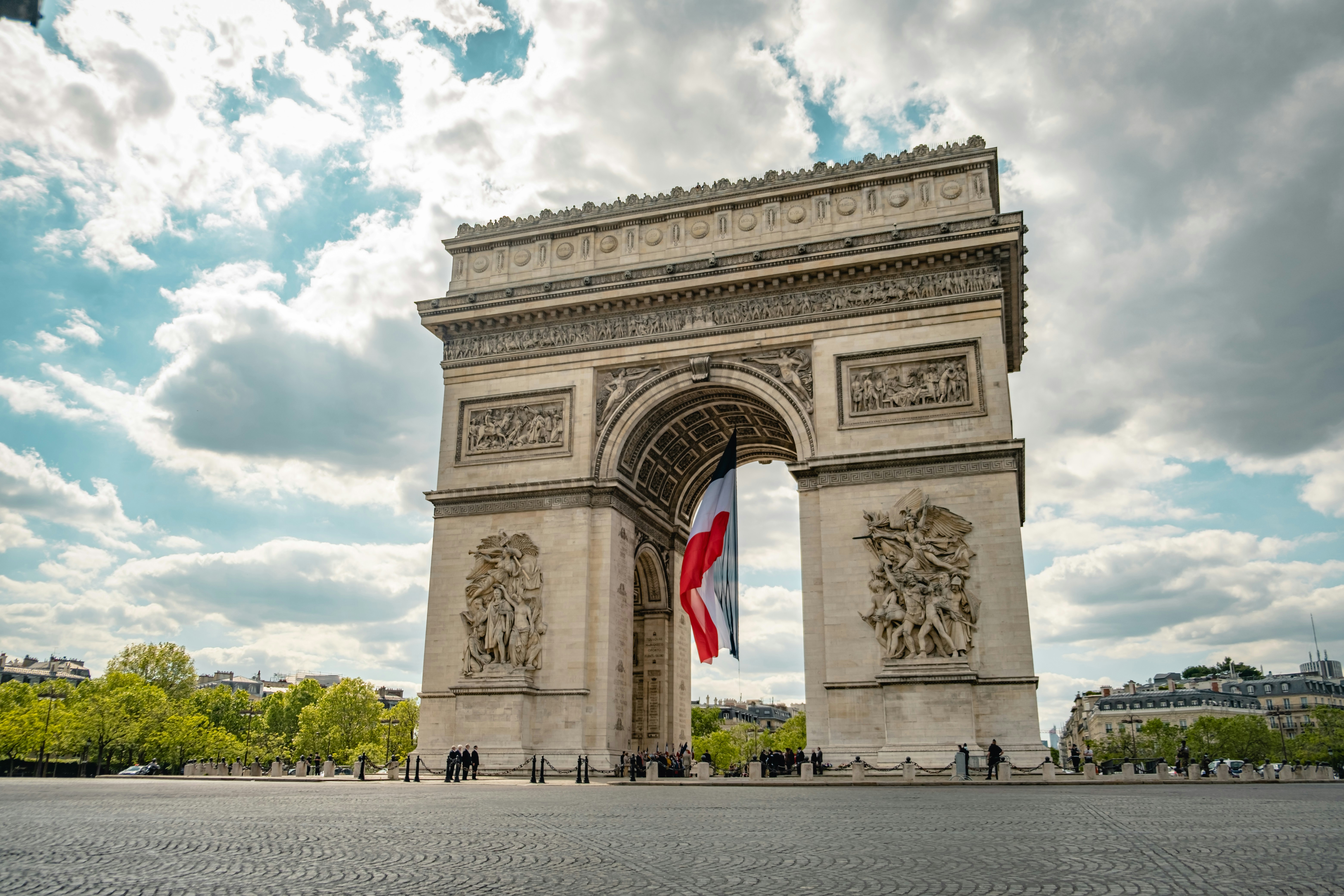 beige concrete arc under white clouds during daytime