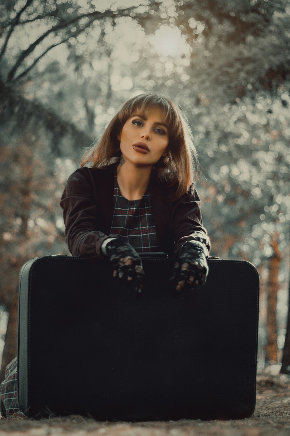 woman in black and white striped long sleeve shirt sitting on black chair