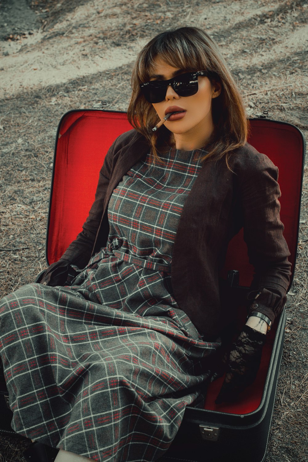 woman in black jacket sitting on red chair