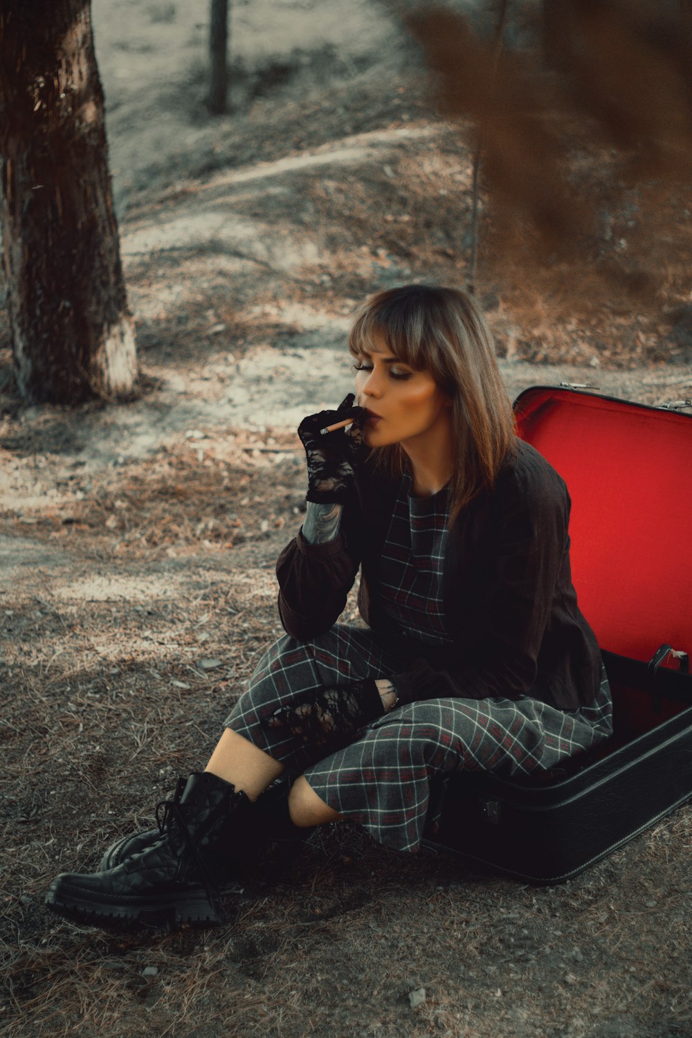 woman in black and white striped long sleeve shirt sitting on red chair