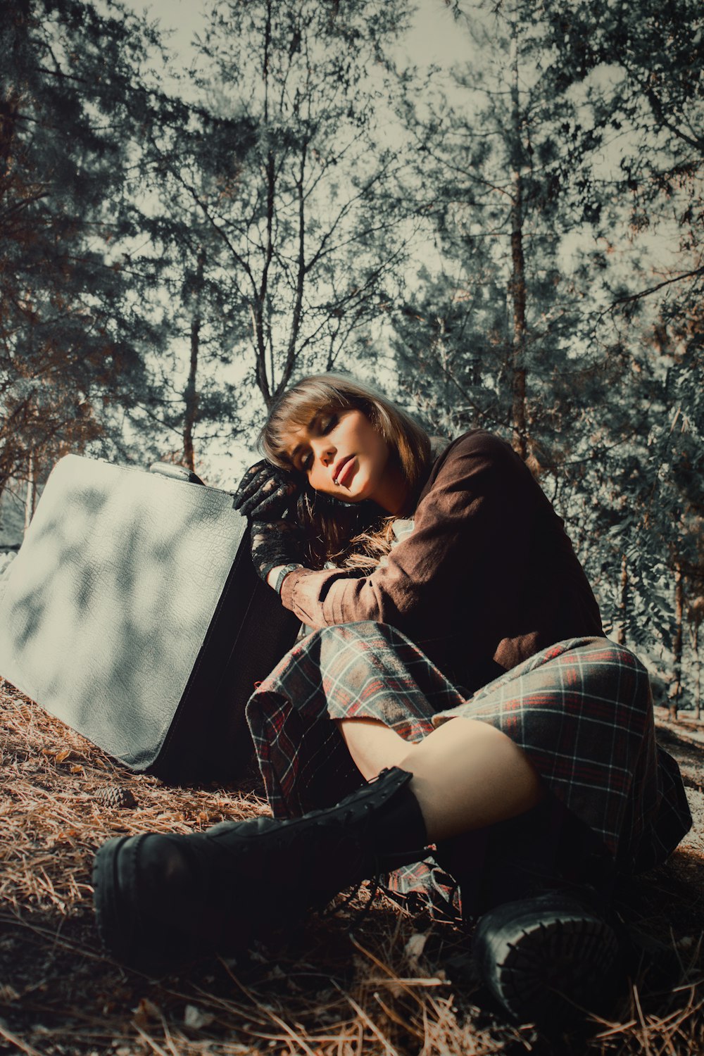 woman in black jacket and plaid skirt sitting on swing chair