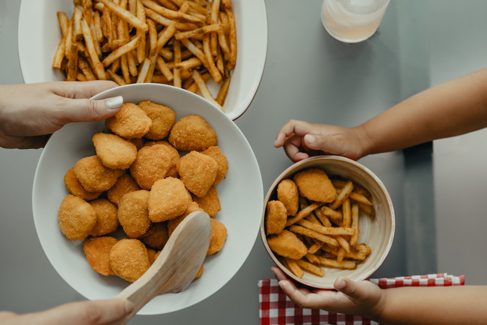 brown potato fries on white ceramic bowl