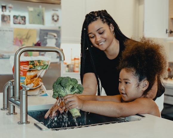 A family cooking in the kitchen with fresh vegetables grown using biotech methods.