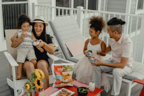 Smiling family receiving a meal package outside a local food pantry.