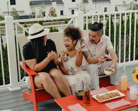 woman in white button up shirt sitting on red chair