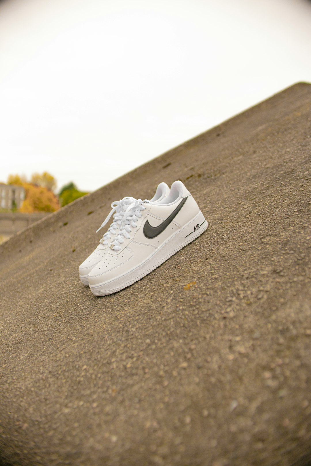 white nike air force 1 low on gray asphalt road during daytime