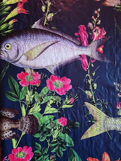Close-up of a Madhubani painting featuring intricate fish and floral motifs in rich reds and blacks