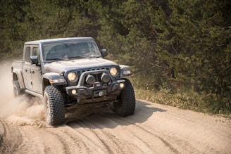 black and white jeep wrangler on dirt road during daytime