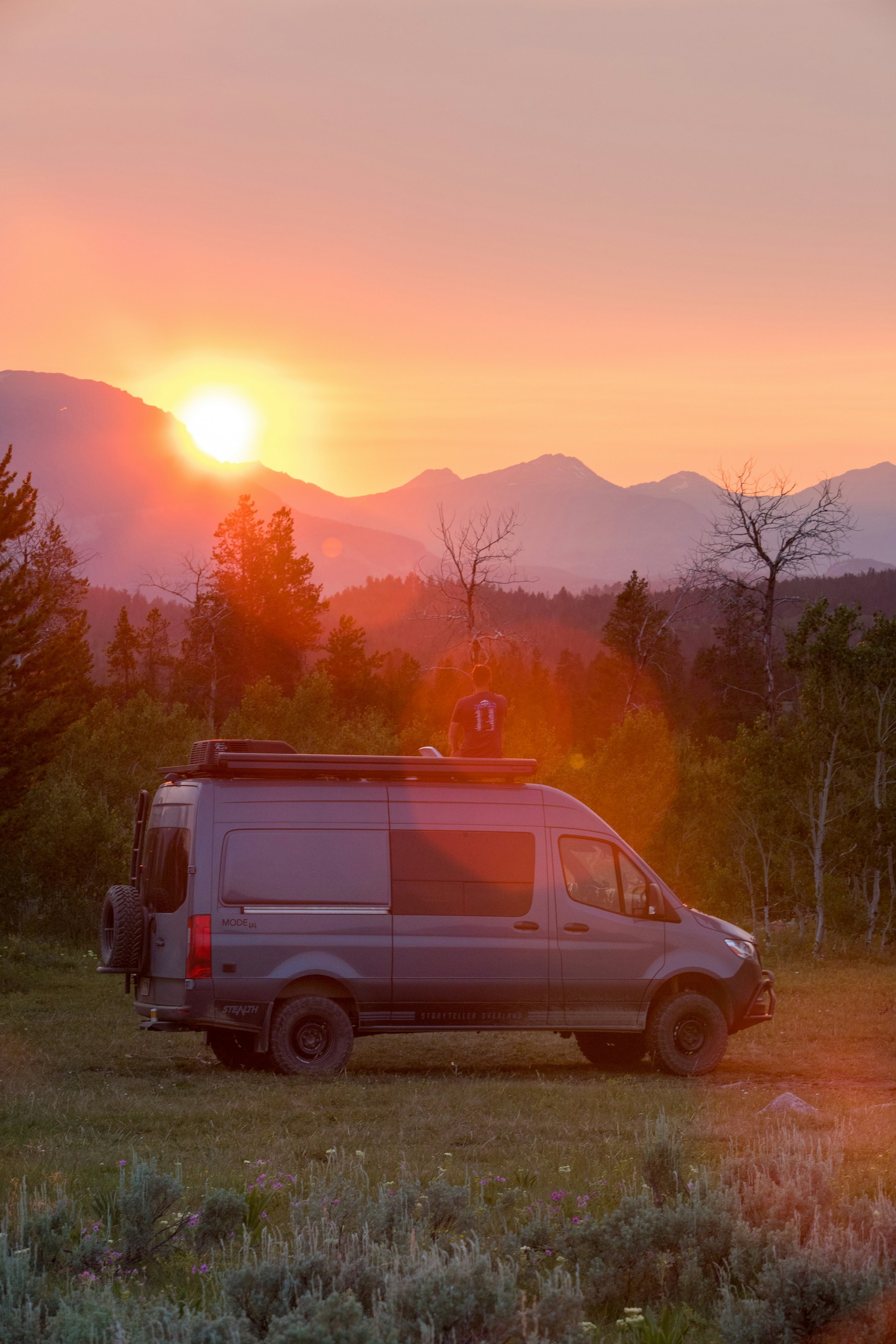 white van parked on green grass field during daytime