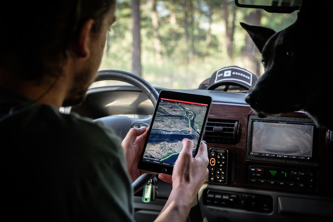 man in gray shirt holding black tablet computer, onX Offroad on an iPad. - Photographer: Chris Cordes / @4x4_touring