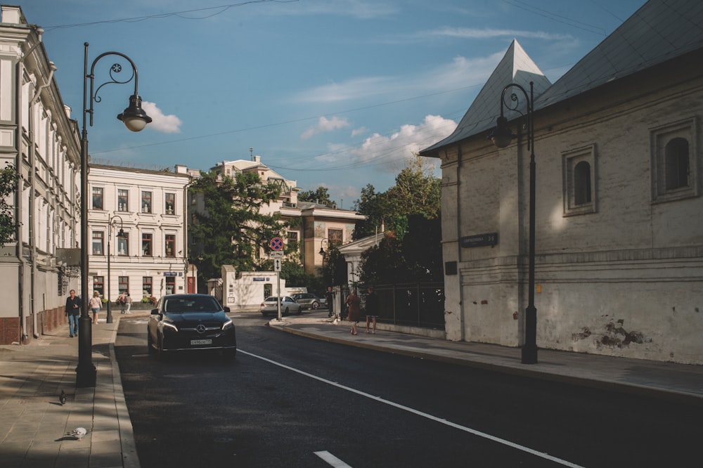 black car on road near building during daytime