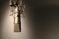 Close-up of a professional microphone in a modern home studio with soft lighting.