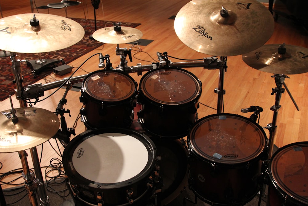 a bunch of drums sitting on top of a hard wood floor