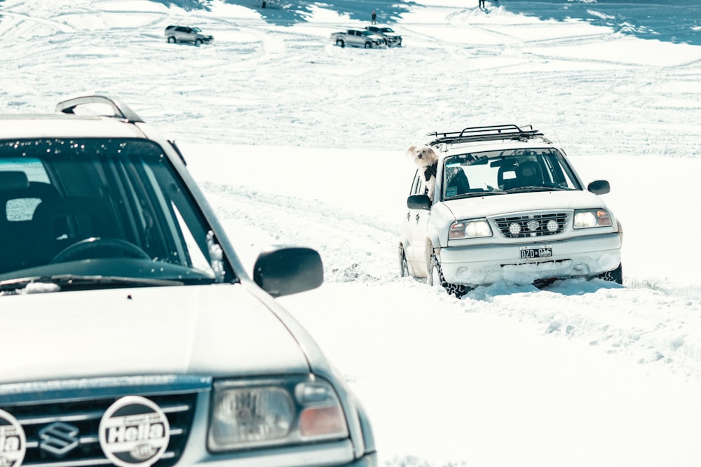 white and black bmw car on snow covered ground during daytime