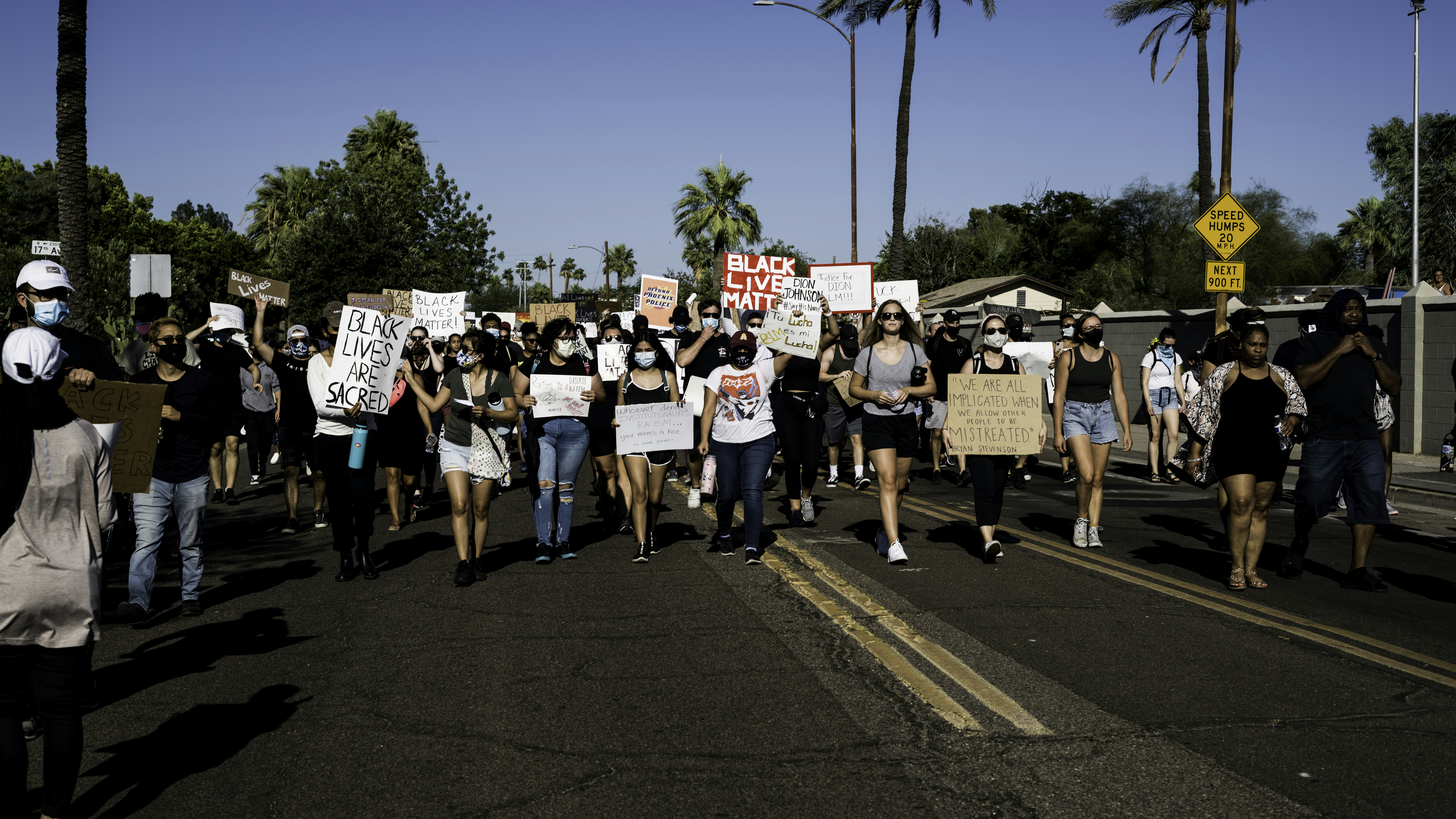people standing on road during daytime
