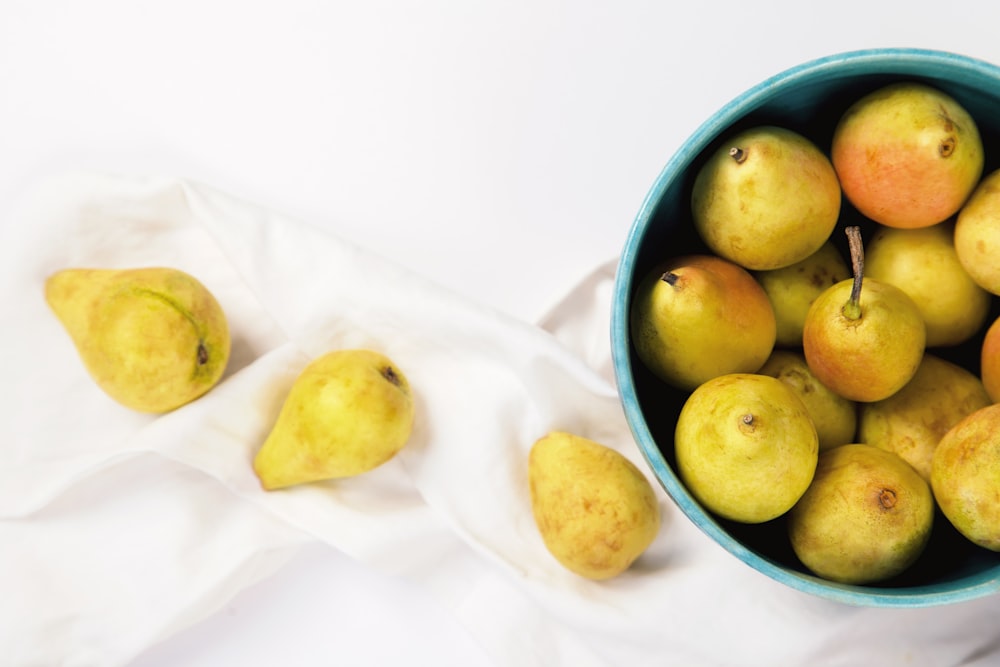 yellow fruits on blue ceramic bowl