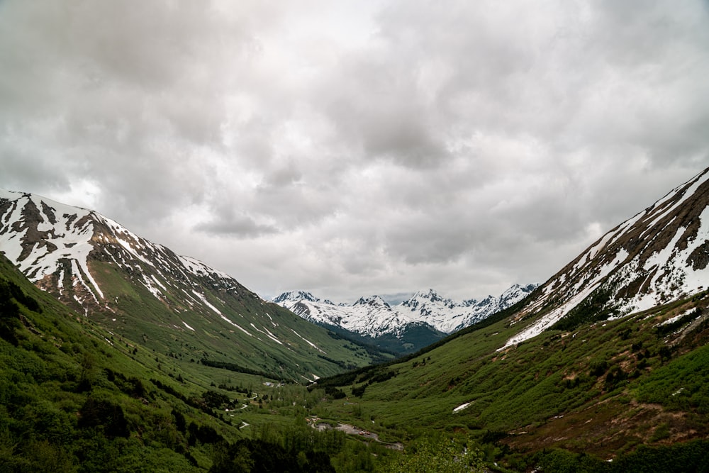 green mountains under white clouds during daytime