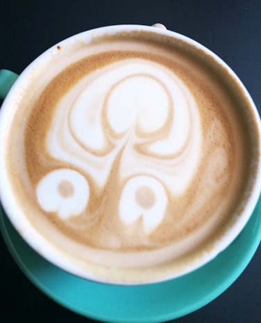 A vibrant cup of latte art with a unique abstract design.