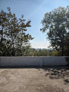 A freshly poured concrete patio with a smooth finish under a clear blue sky.