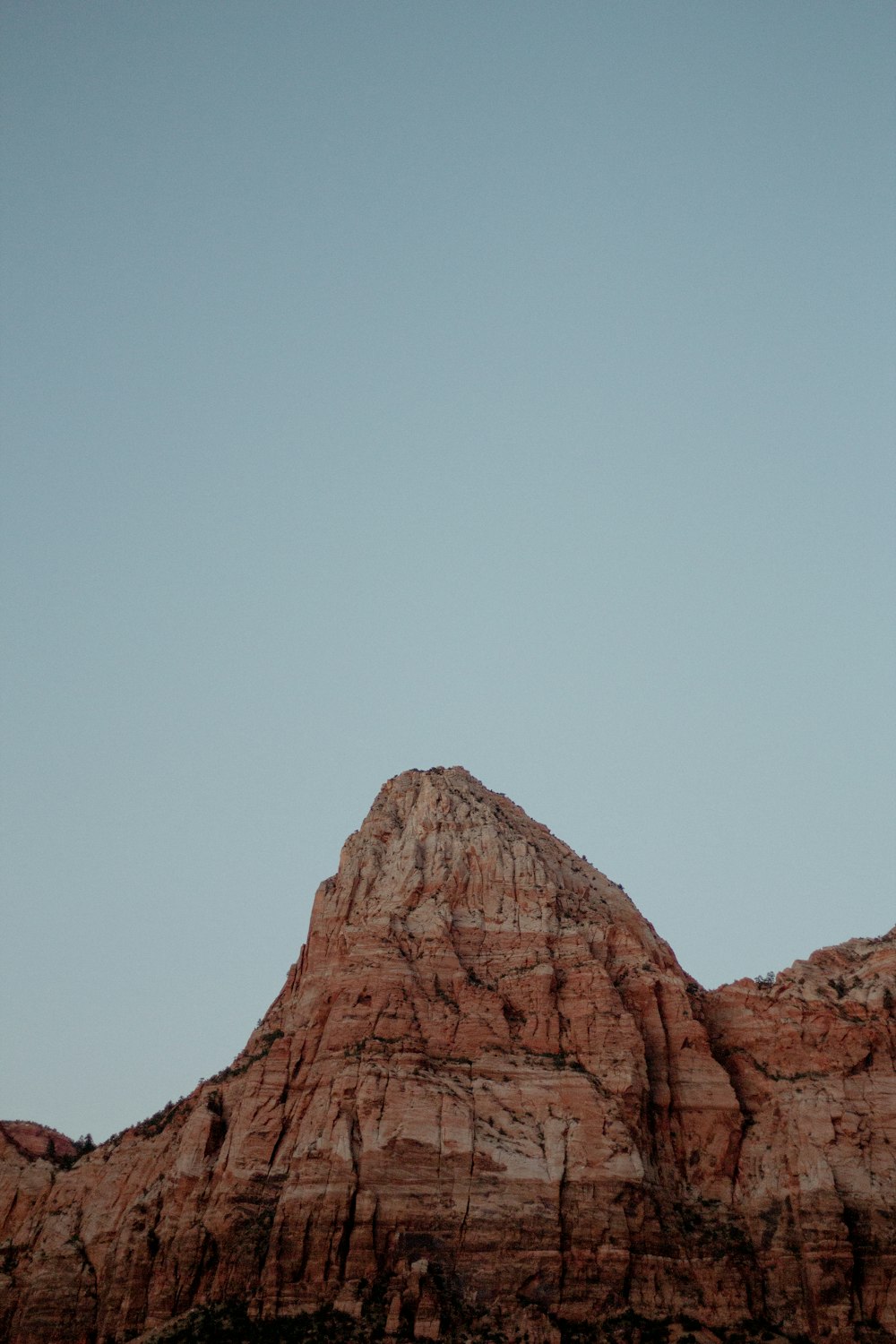 brown rock formation under white sky during daytime