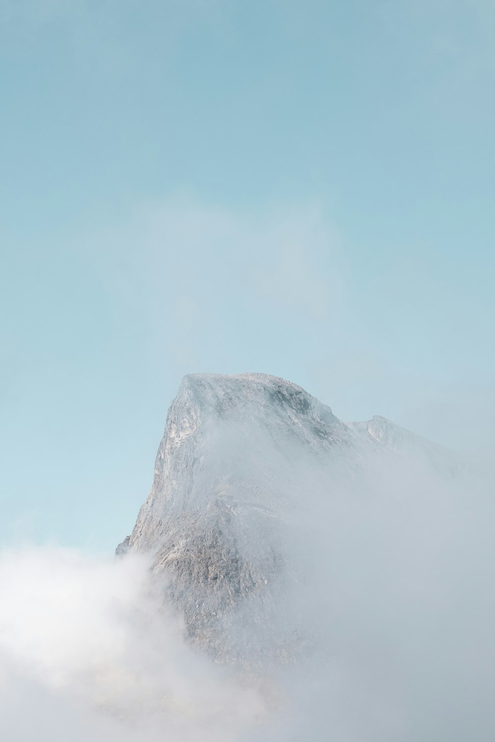 white clouds over black mountain