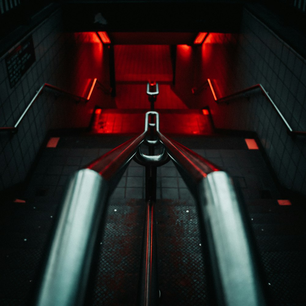 red and black tunnel with stainless steel railings