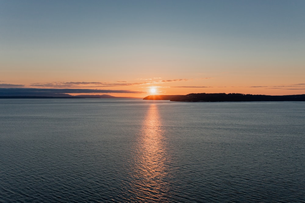 body of water during sunset